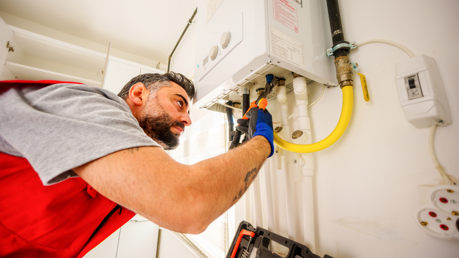 Engineer diagnosing a no hot water fault in London